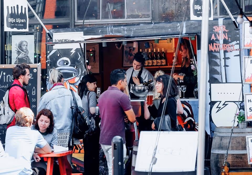 Crowd of people lined up to order from a food truck