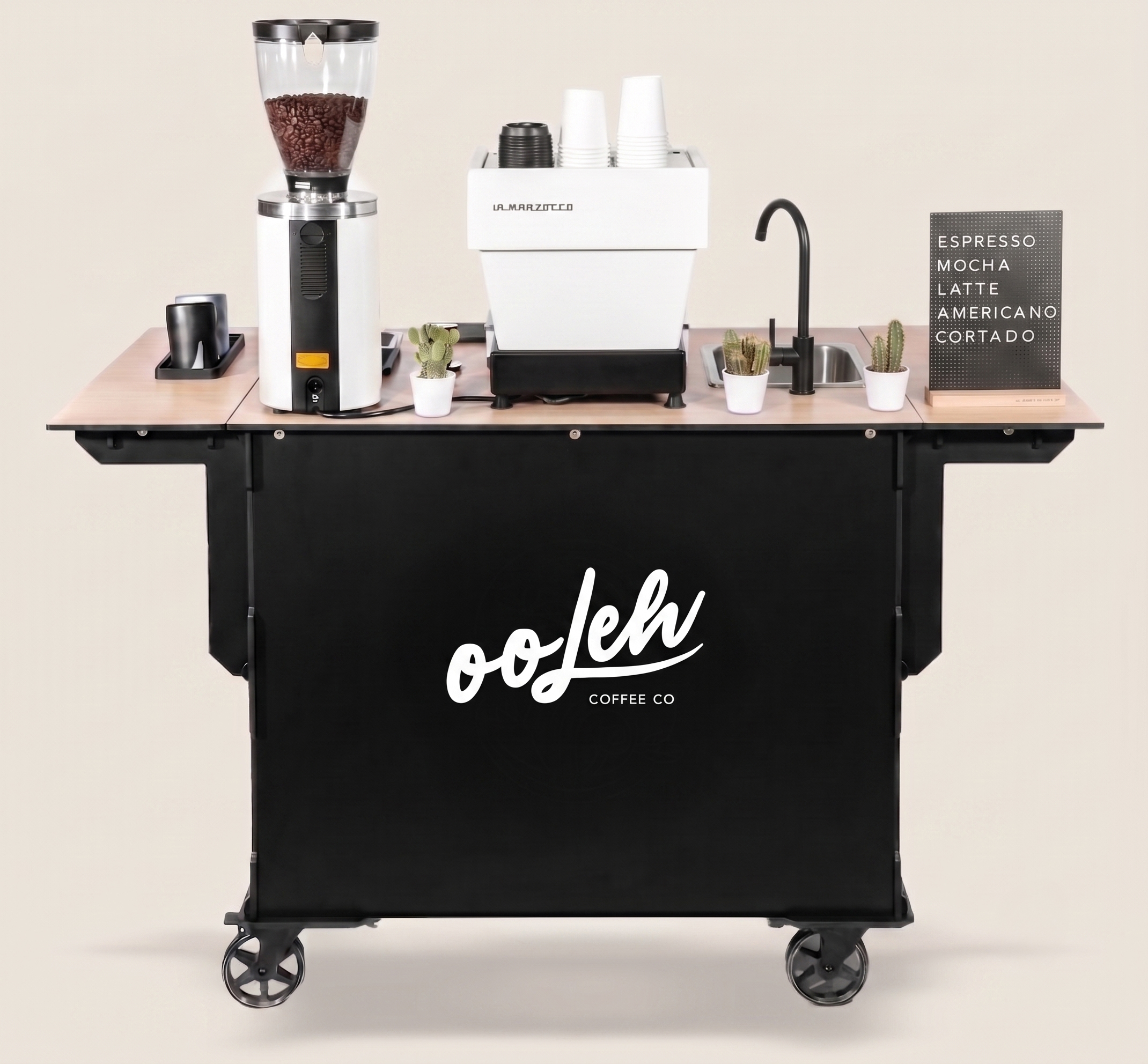 The Ooleh Coffee Co black mobile coffee cart with espresso machine, grinder, and wing extensions