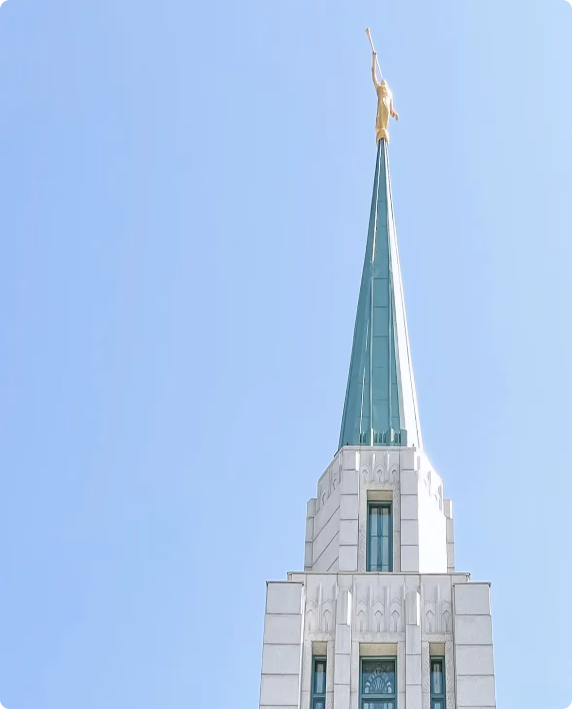 Top of a Mormon church building against a blue sky
