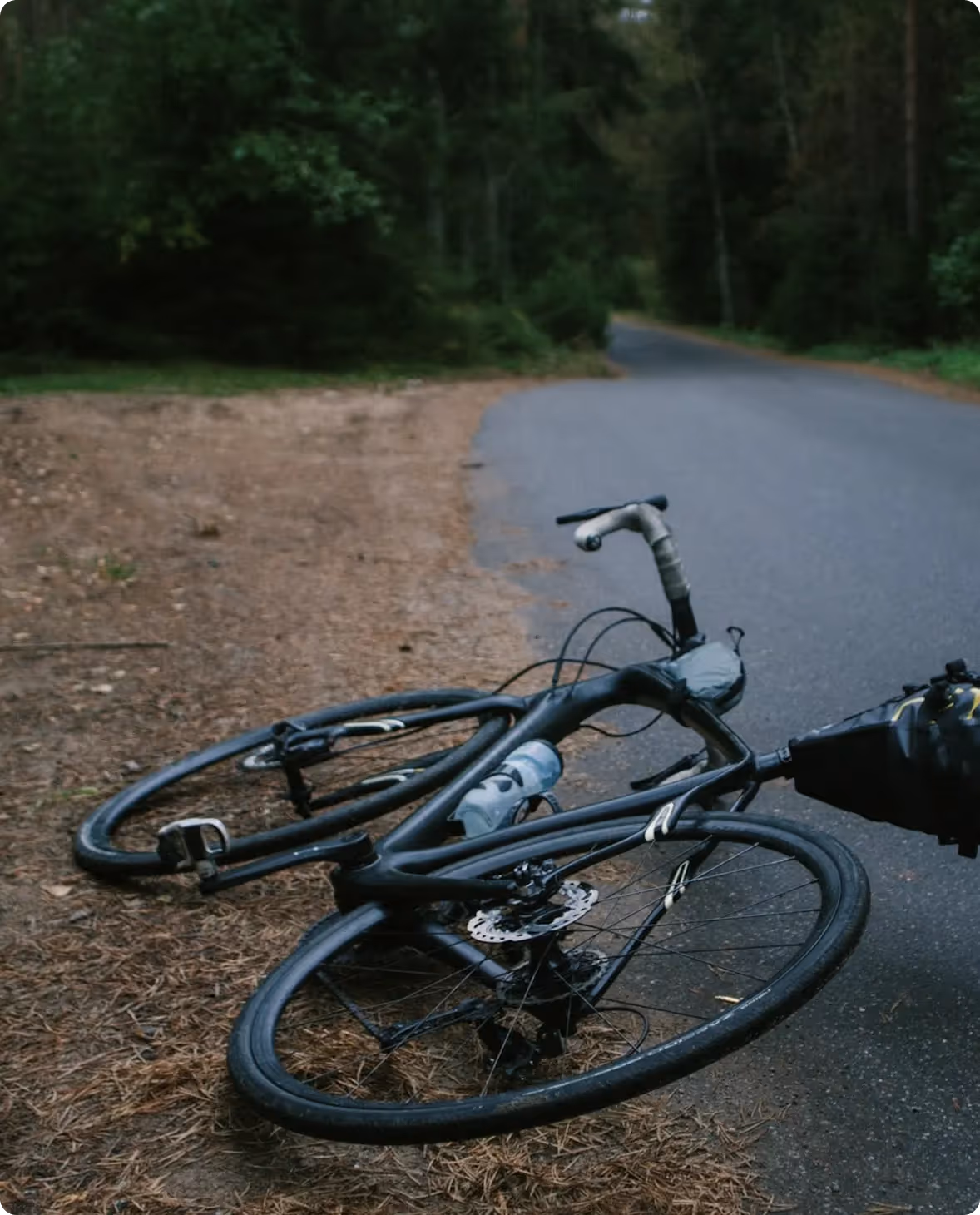 Broken bicycle lying on the side of the road after an accident