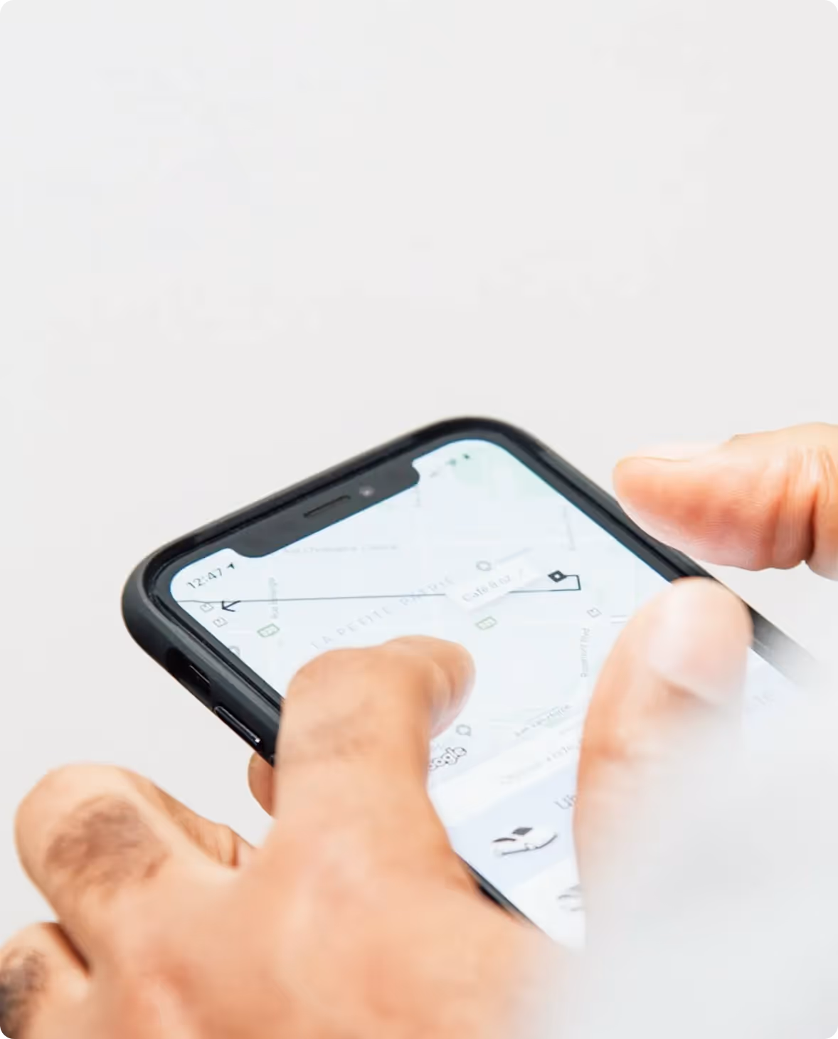 Person using a rideshare app to order an Uber or Lyft ride