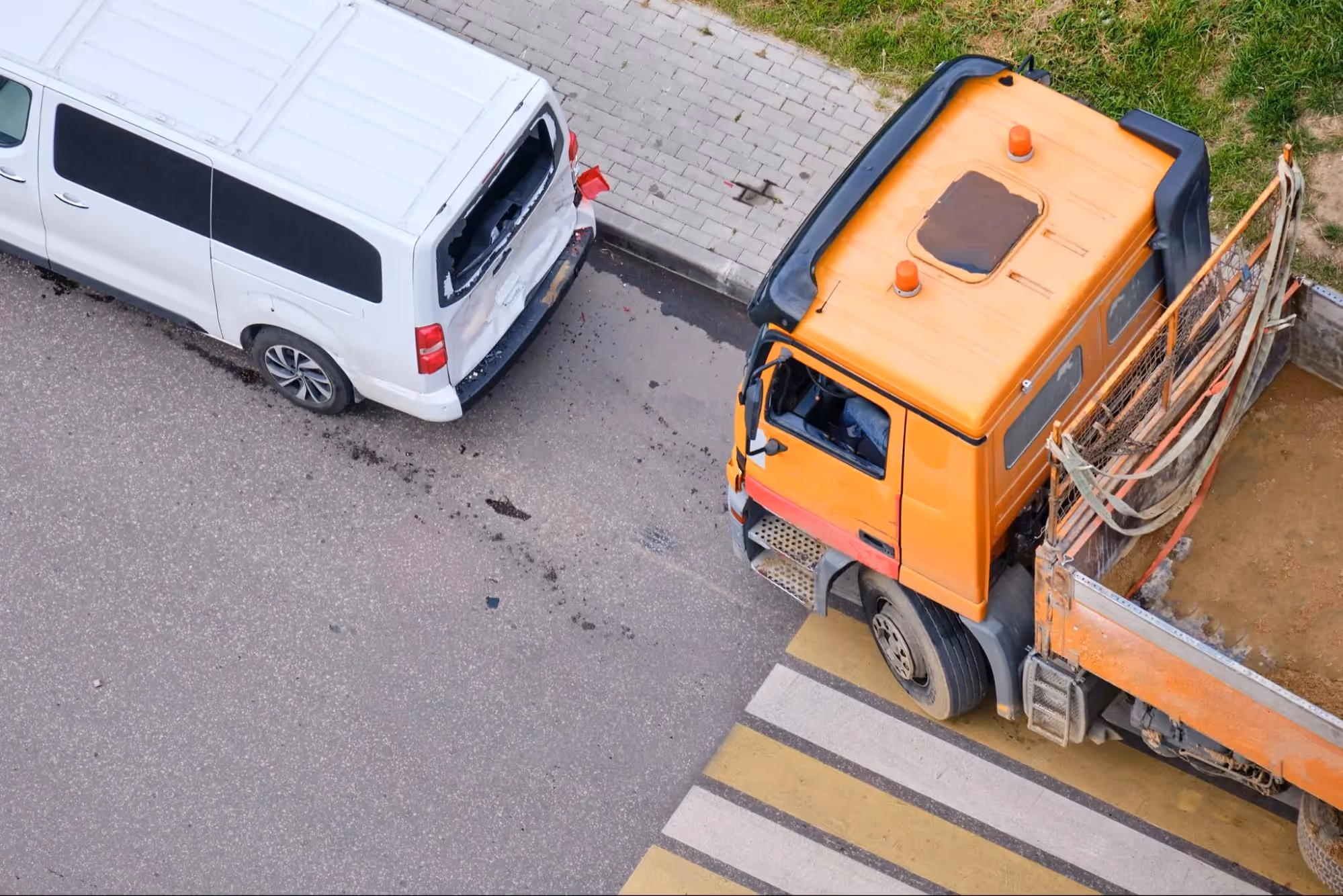 White van and orange truck involved in a collision in California