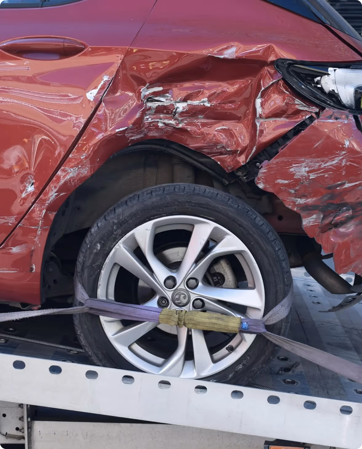 Red car severely damaged after a car accident