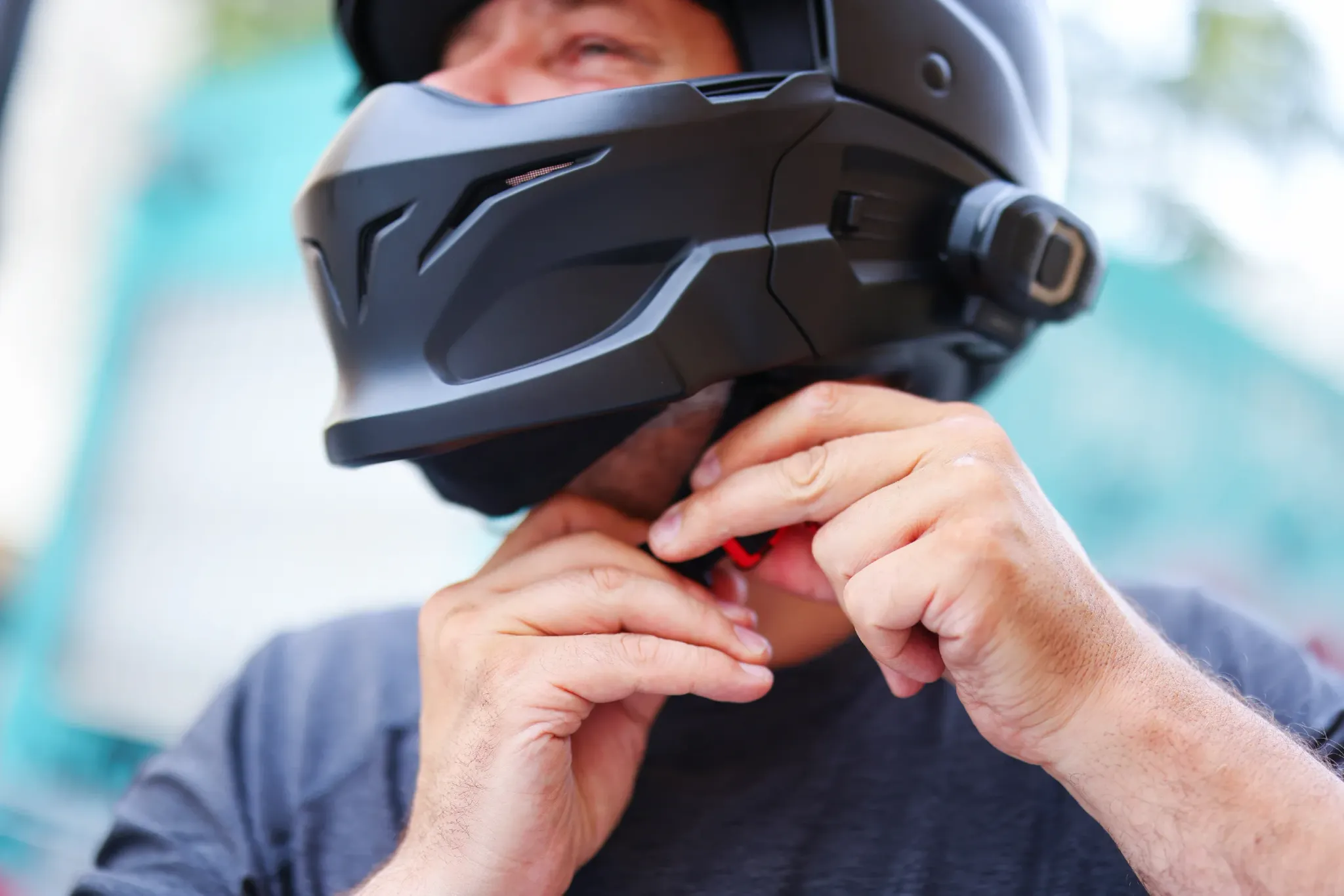 Man strapping on his motorcycle helmet in Georgia