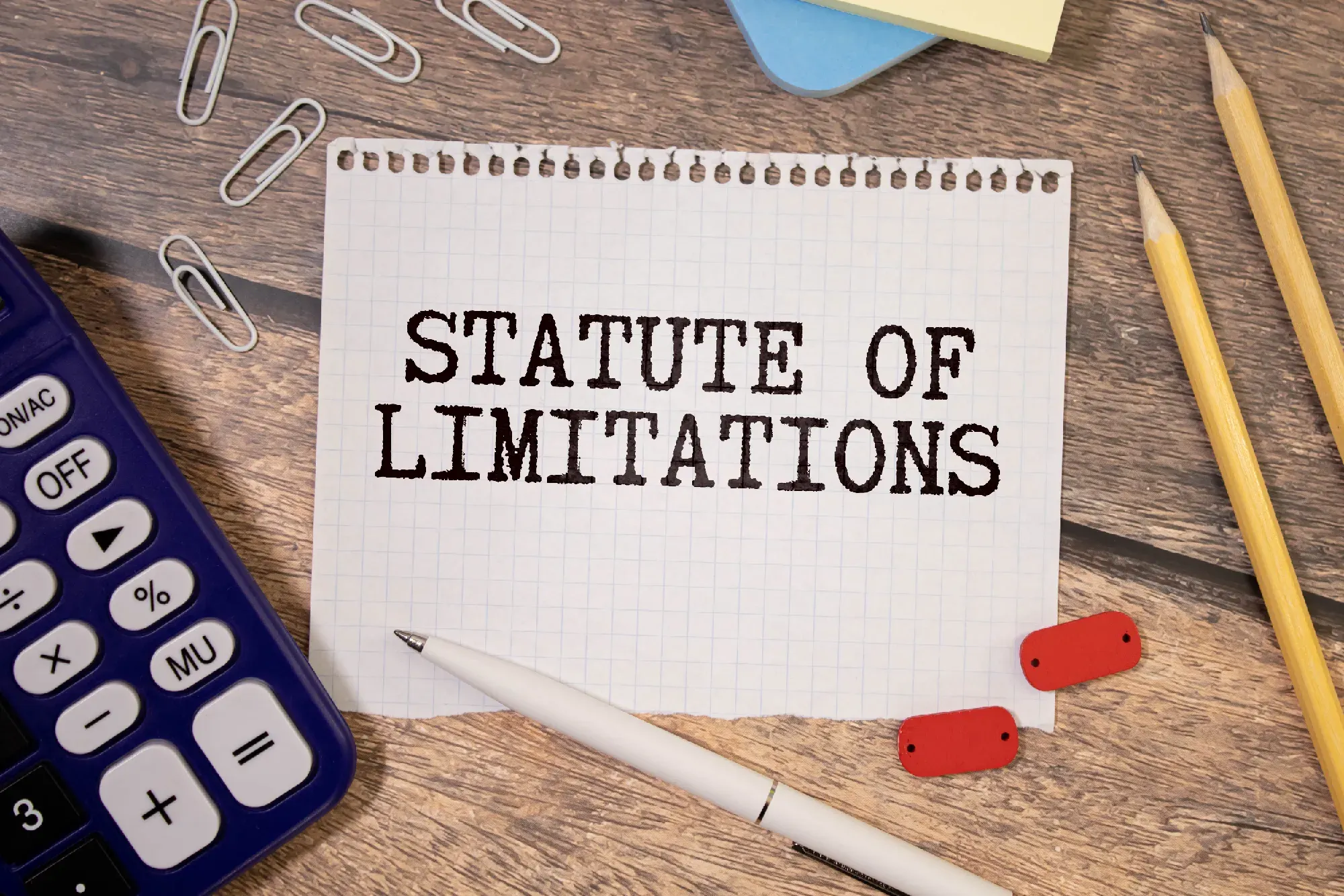 Paper on desk with the words statute of limitations written on it