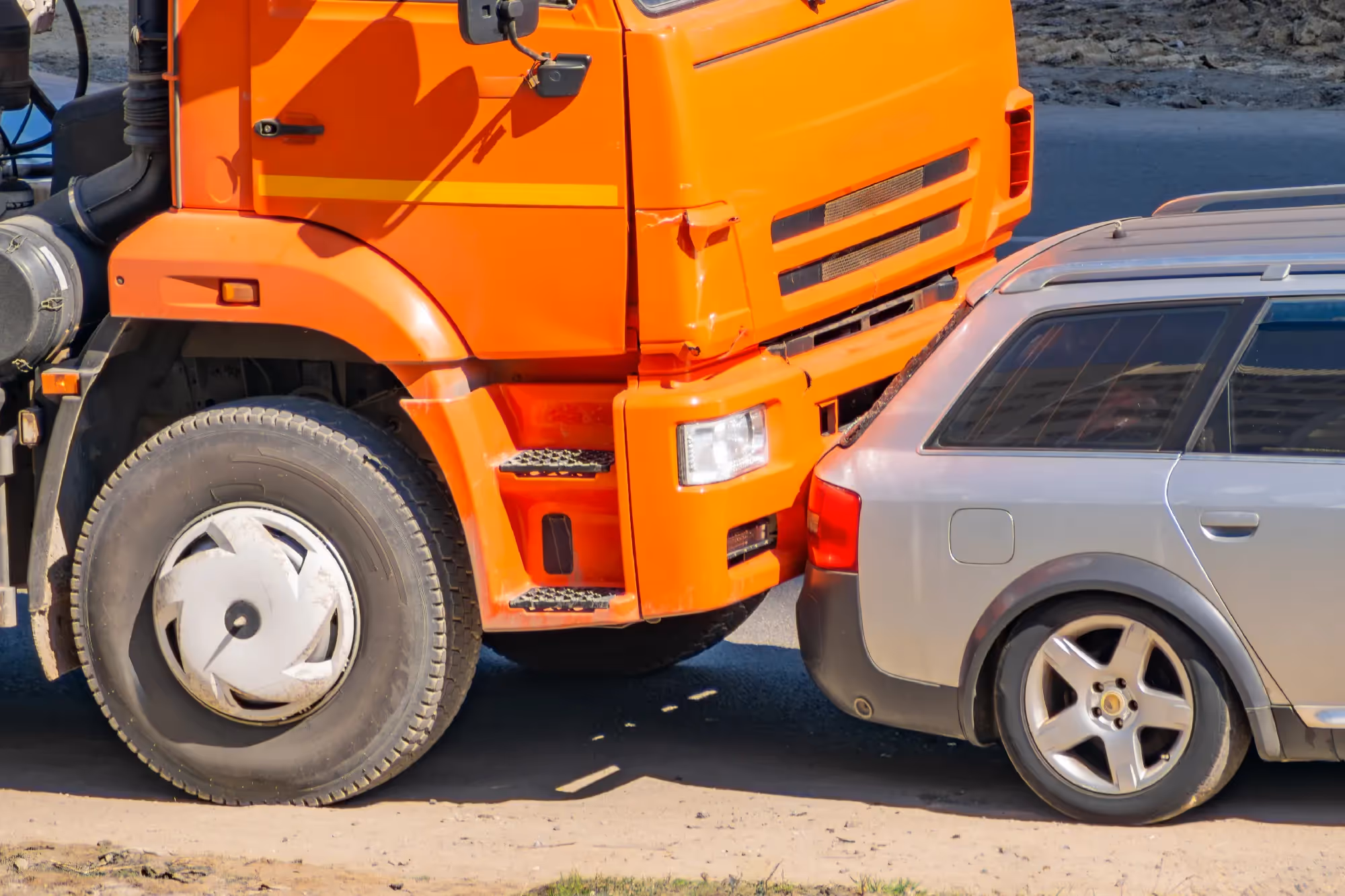 orange truck rear-ending a gray car in a California traffic accident