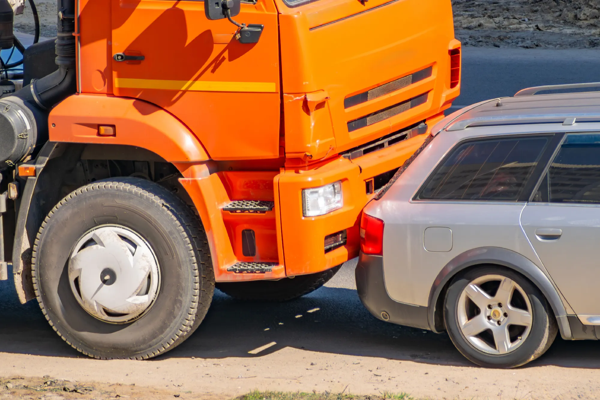 orange truck rear-ending a gray car in a California traffic accident