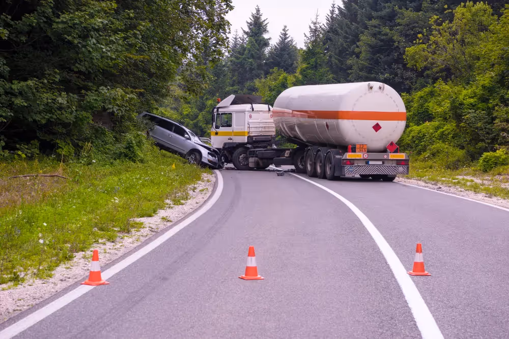 Commercial truck involved in a collision with a gray car