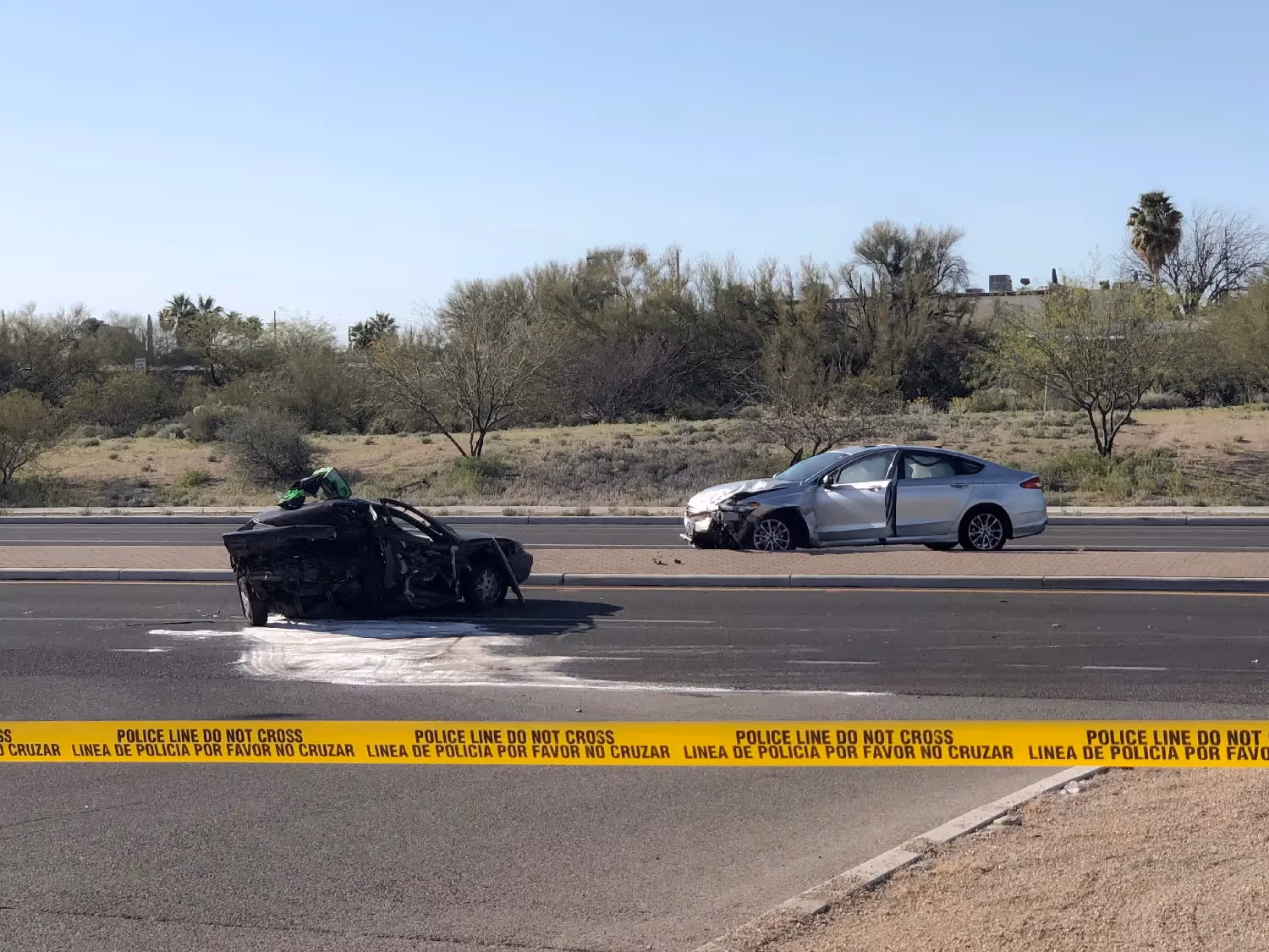 Two cars crashed with yellow police tape blocking the scene in Arizona