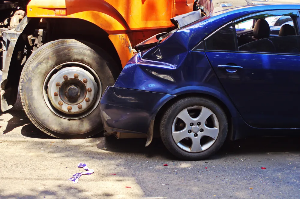 Blue car involved in a truck accident in Phoenix
