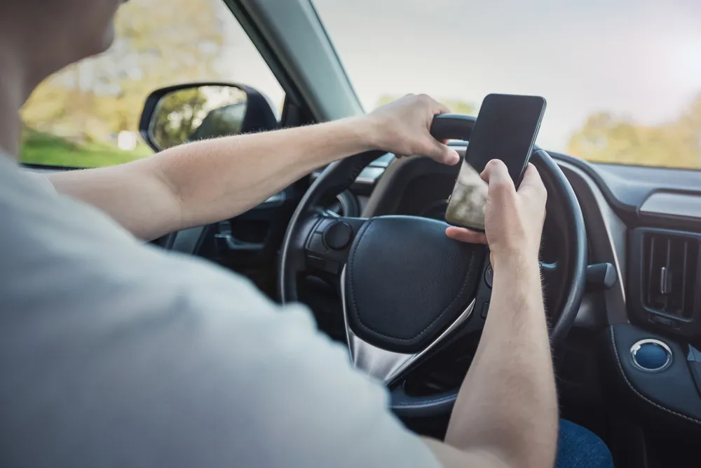 Driver looking at a phone while driving in Atlanta