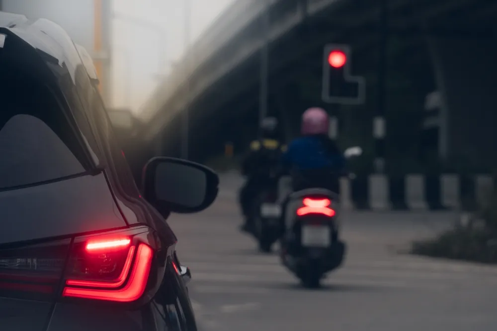 Car stopped behind two motorcycles at a traffic light in Phoenix