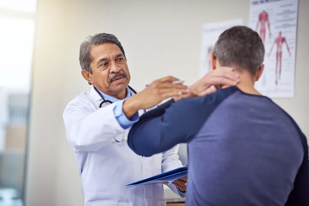 Doctor examining a patient's neck after a minor car accident