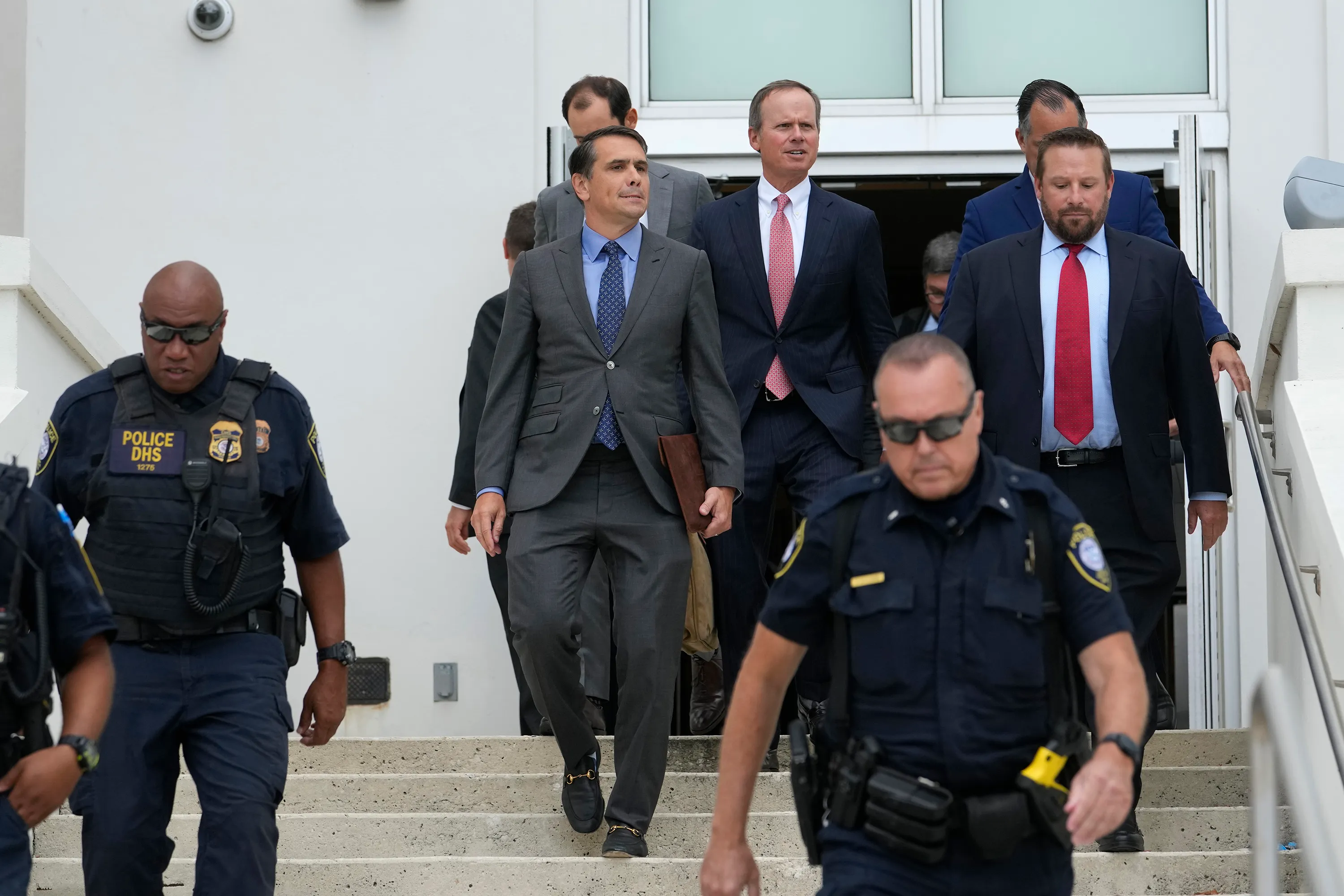 Defense attorneys  Todd Blanche and Chris Kise walking down stairs.
