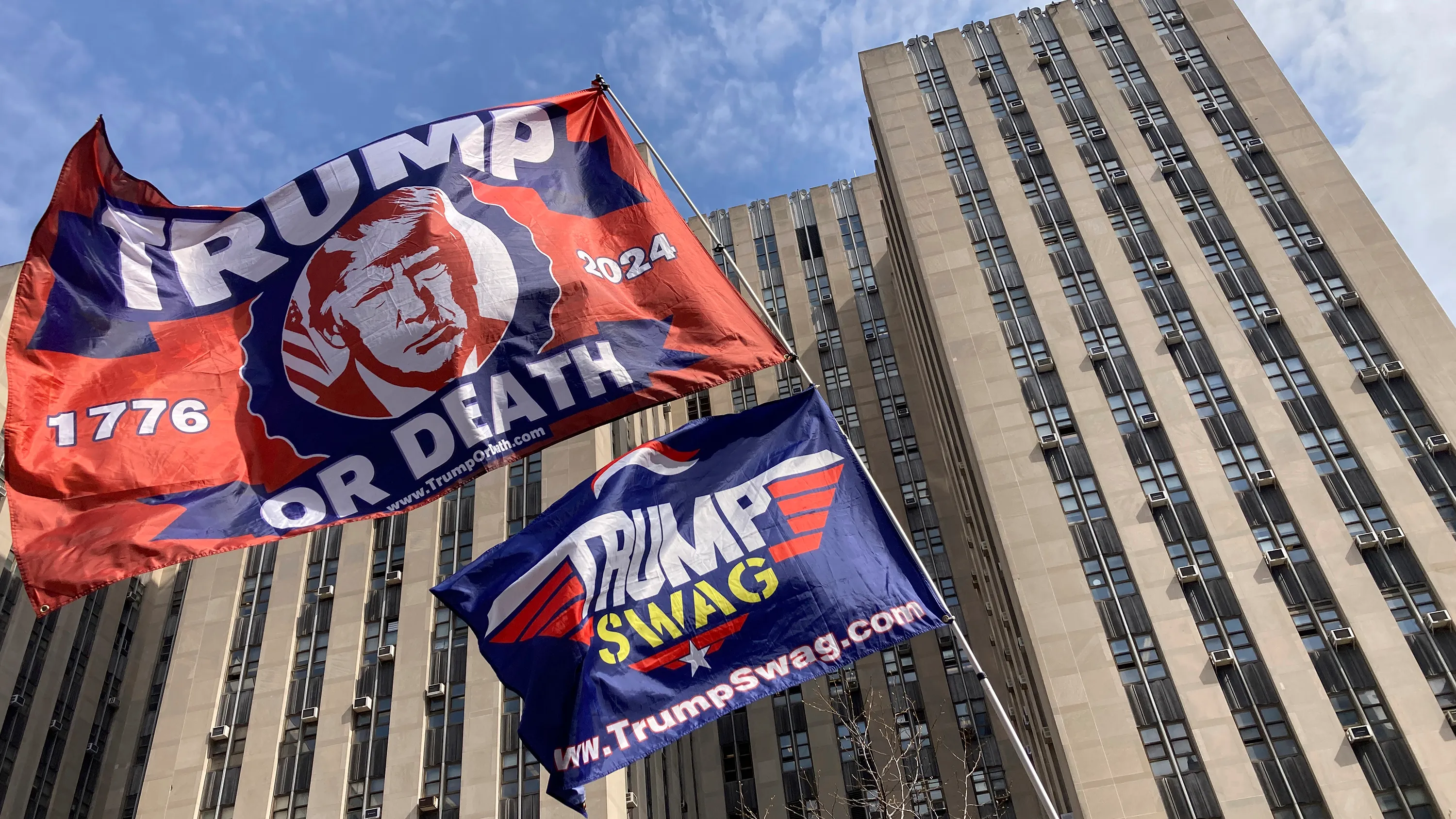2 Donald Trump flags waving in the wind.