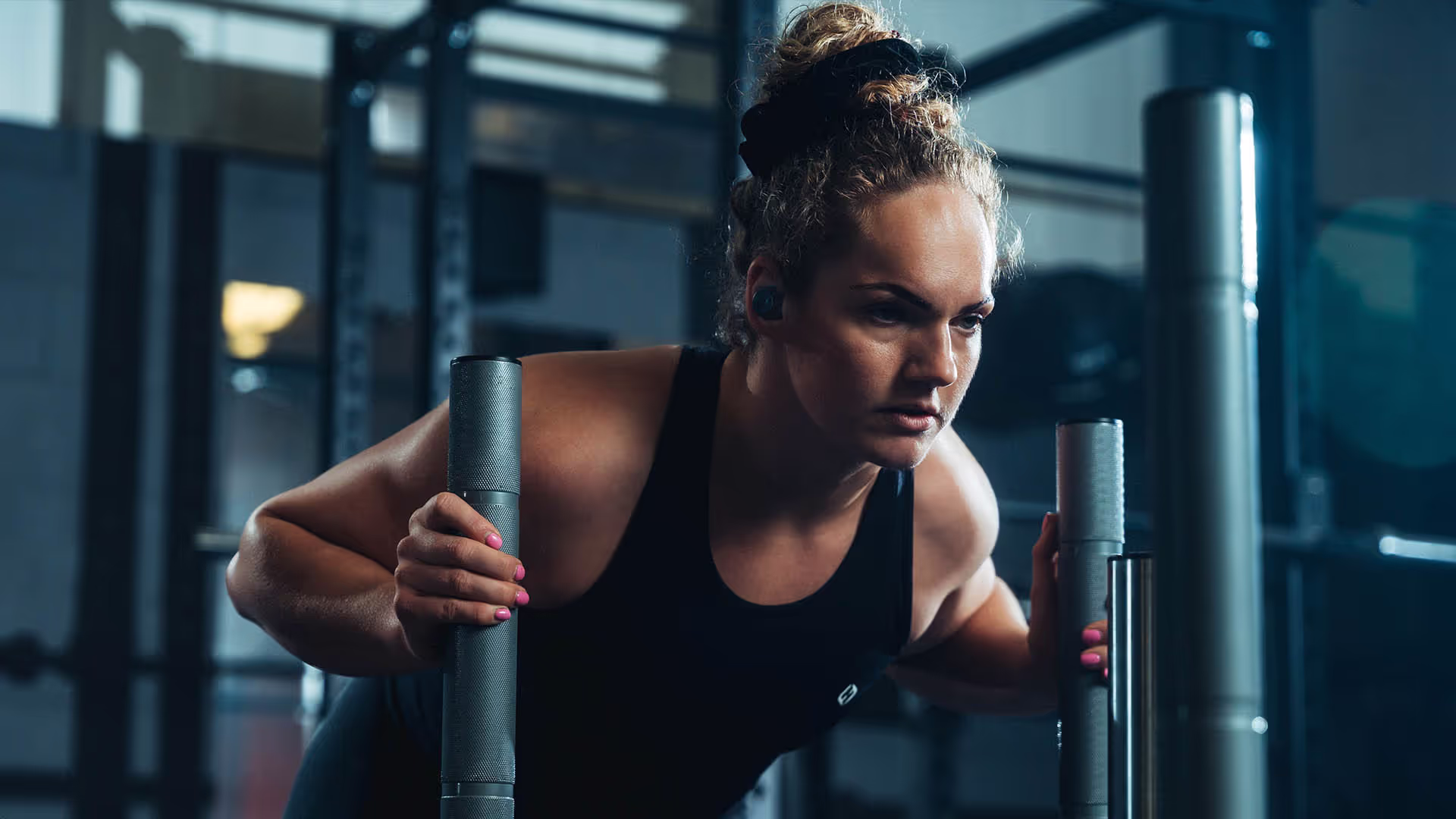 A women in a gym using sled push