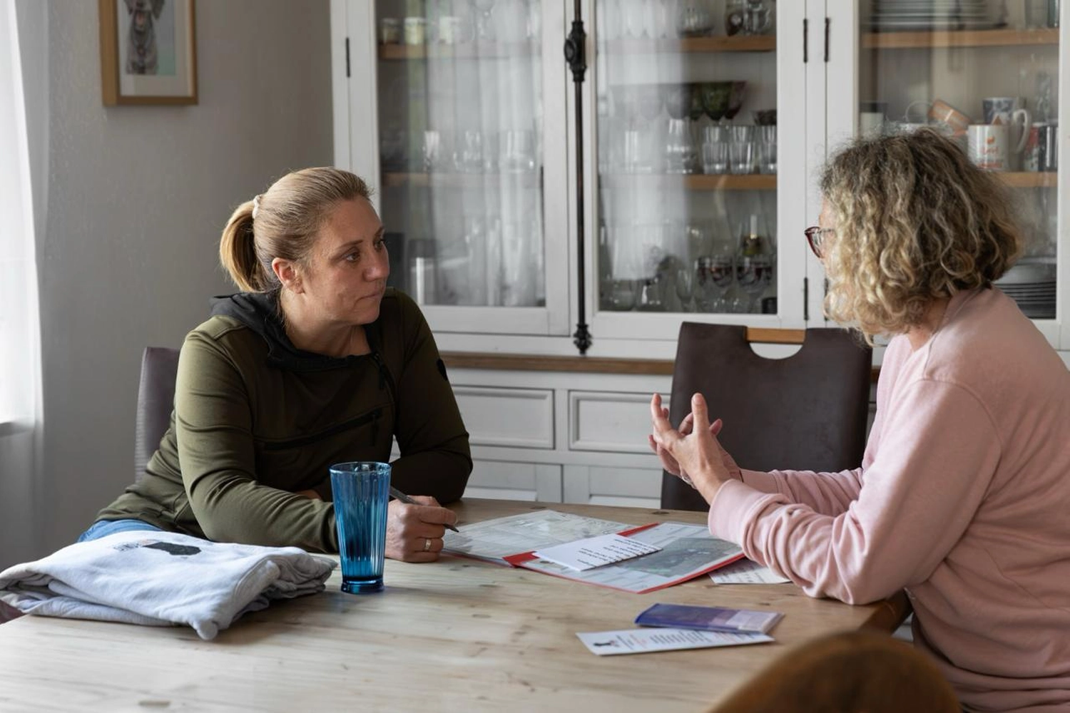 Hübscher goldfarbener Hund sitzt am Cafétisch mit leckerem Essen. Willkommenskonzept für Hunde