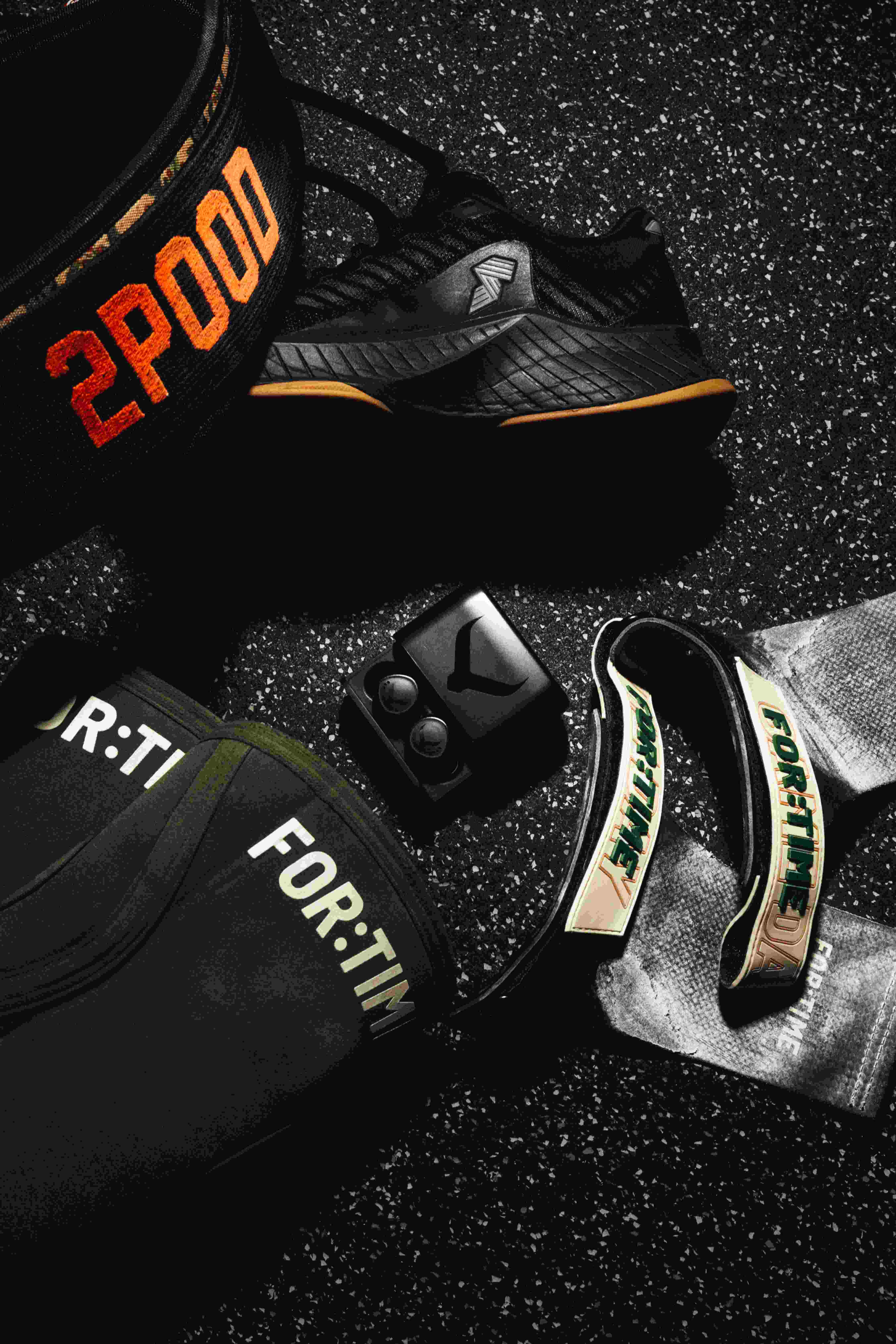 Tzuka earbuds in a gym bag — essential kit for phone-free hybrid athlete training