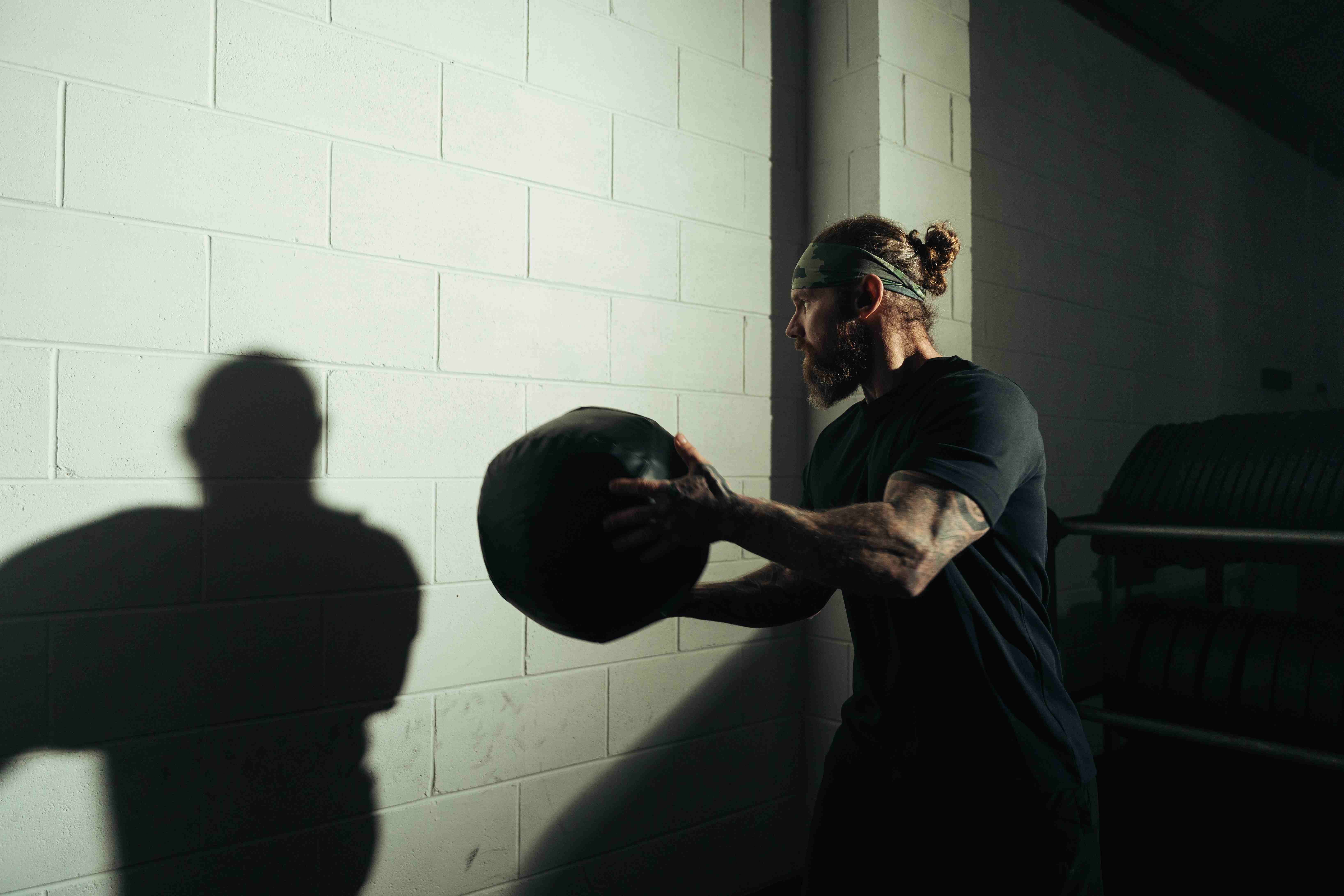 Athlete pushing weighted sled during a HYROX training plan session