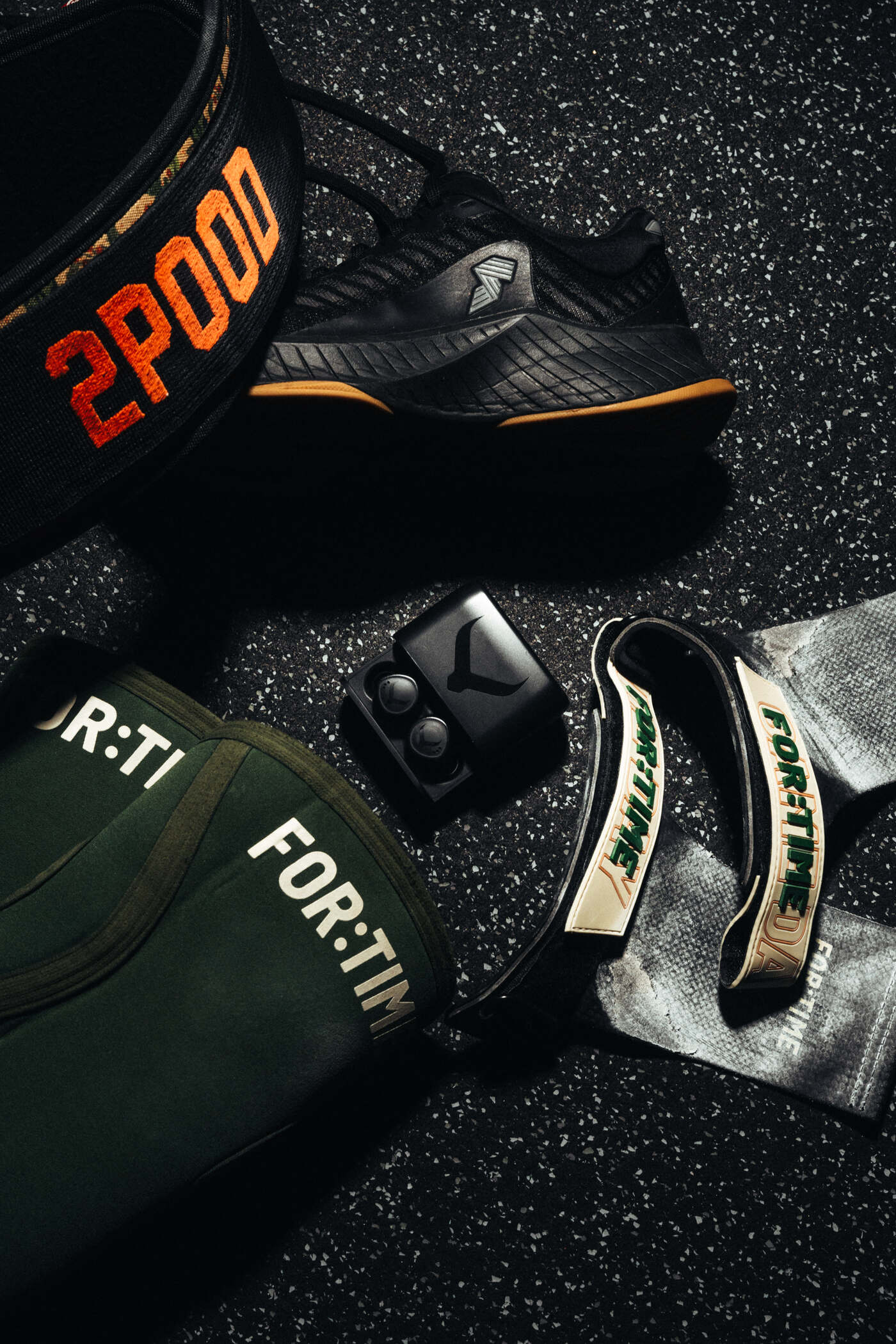 Tzuka TZ7 Ultra earbuds and case laid out with chalk, grips and a skipping rope