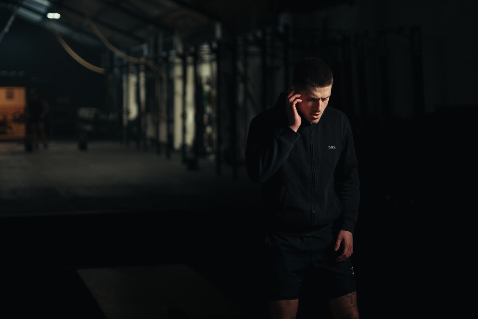 Athlete pressing the touch control on a Tzuka earbud with no phone present