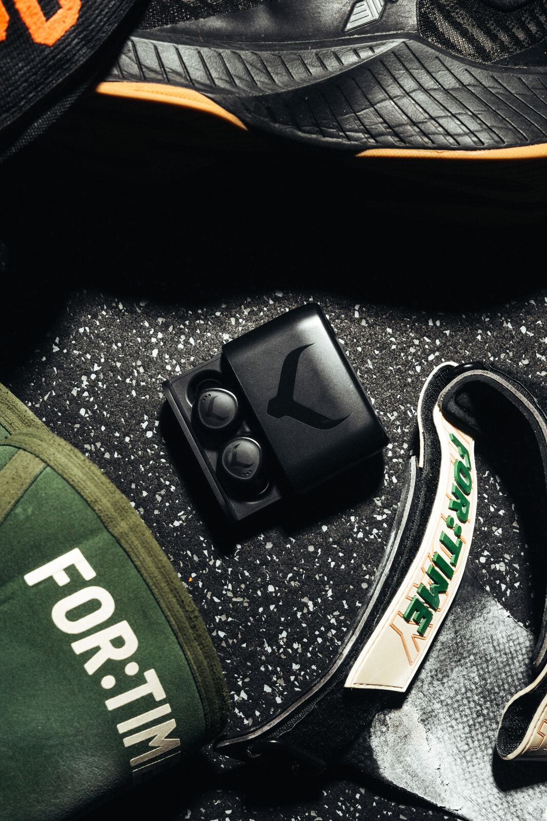 Tzuka TZ7 Ultra earbuds and case packed among gym bag essentials