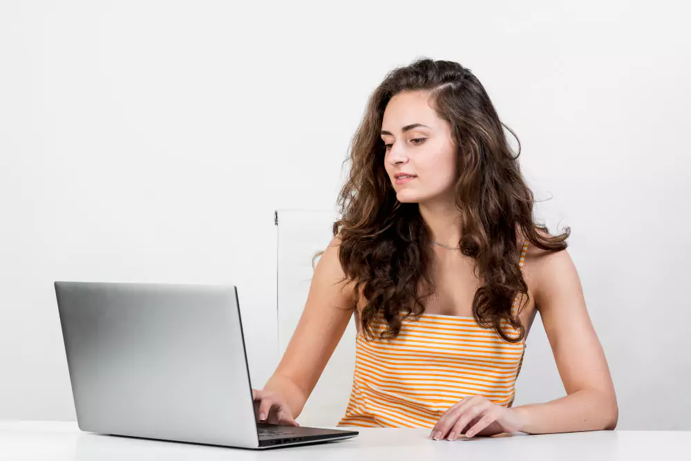 Girl check experience at airbnb on her resume with her laptop