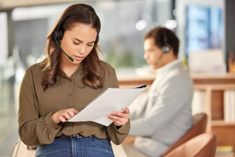 Business woman reading notes on customer service and consulting job in office