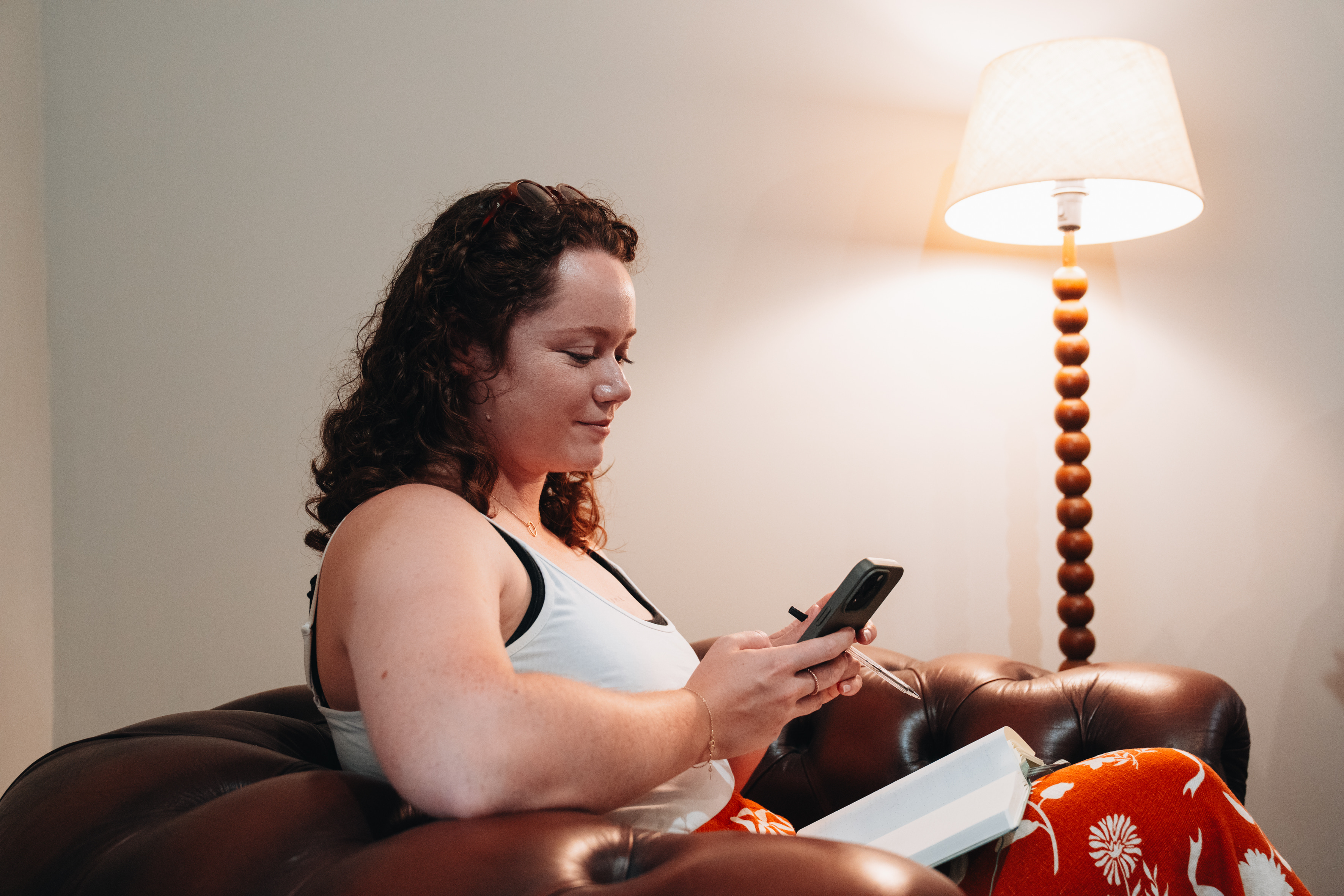 our coliver reading her book and browsing on her phone