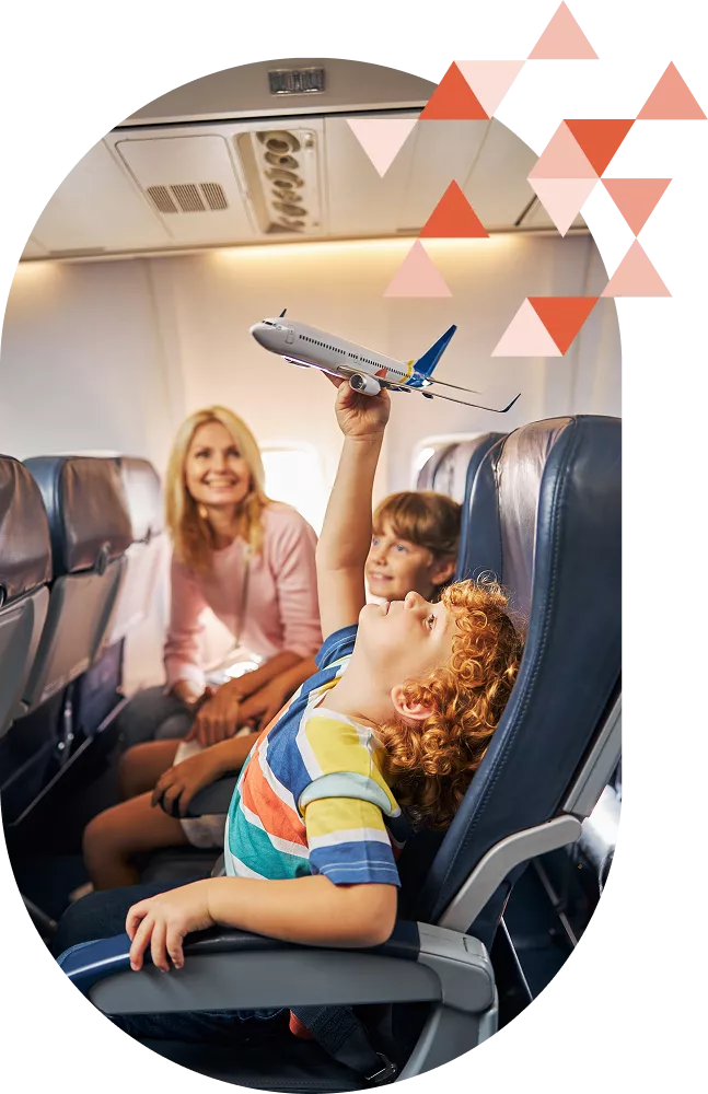 Family sitting on an airplane with child holding a toy airplane