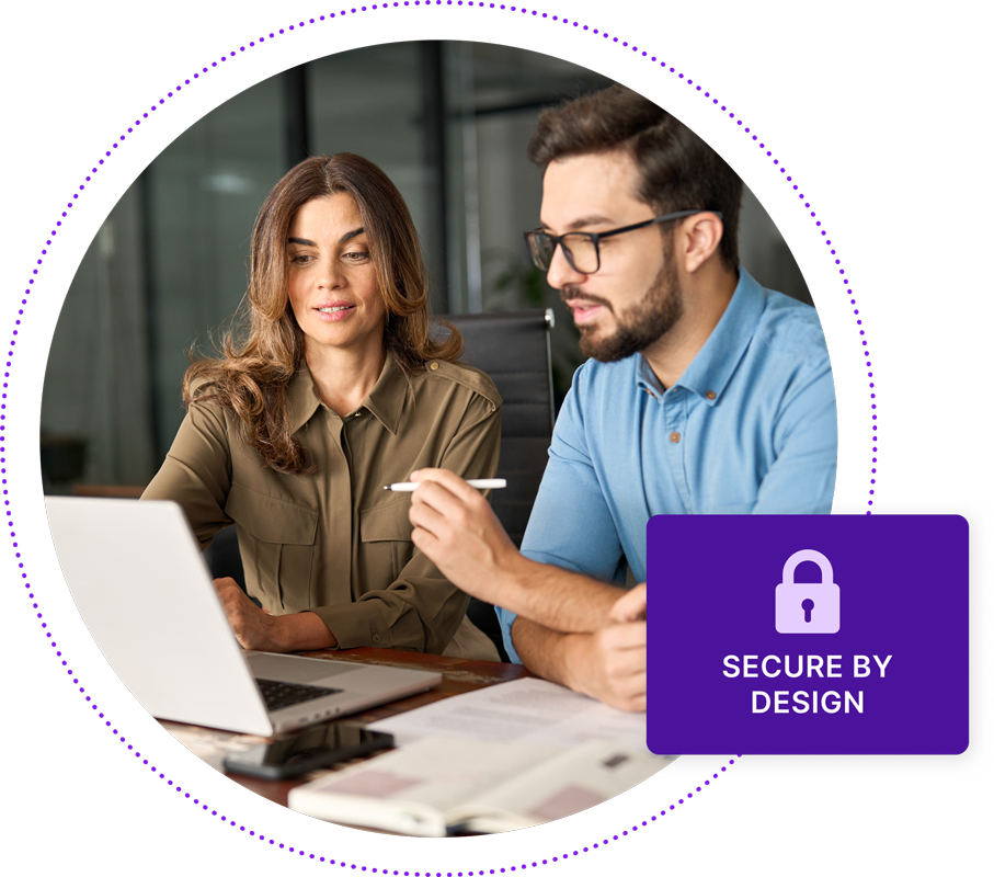 Two coworkers consulting over a laptop