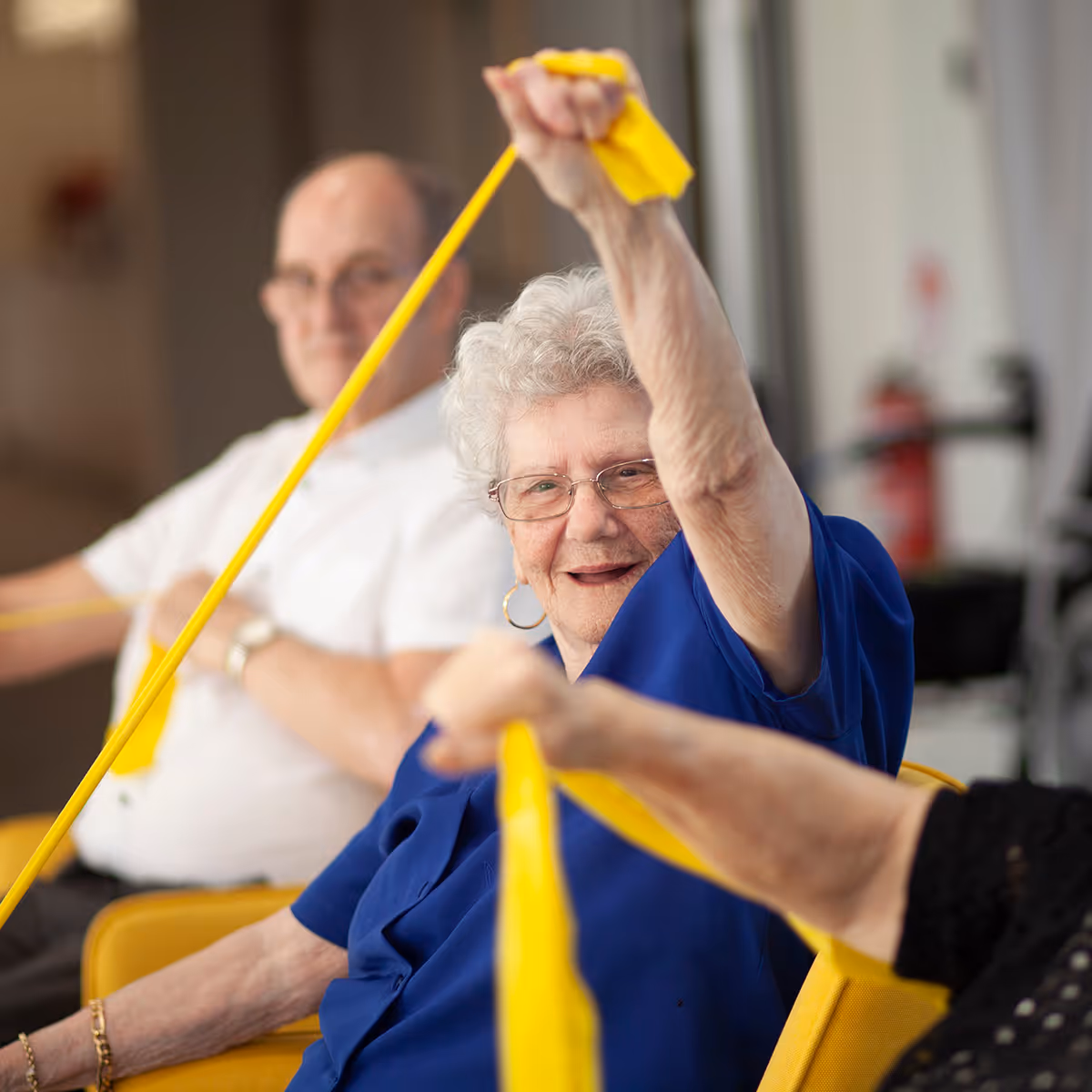 Oxa Care residents exercising with resistance bands