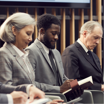 Attendees taking notes during a presentation