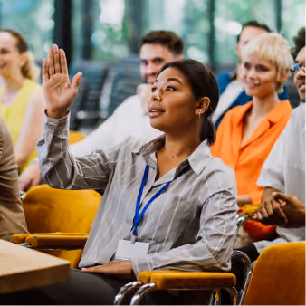 Attendee raising a hand during a conference session