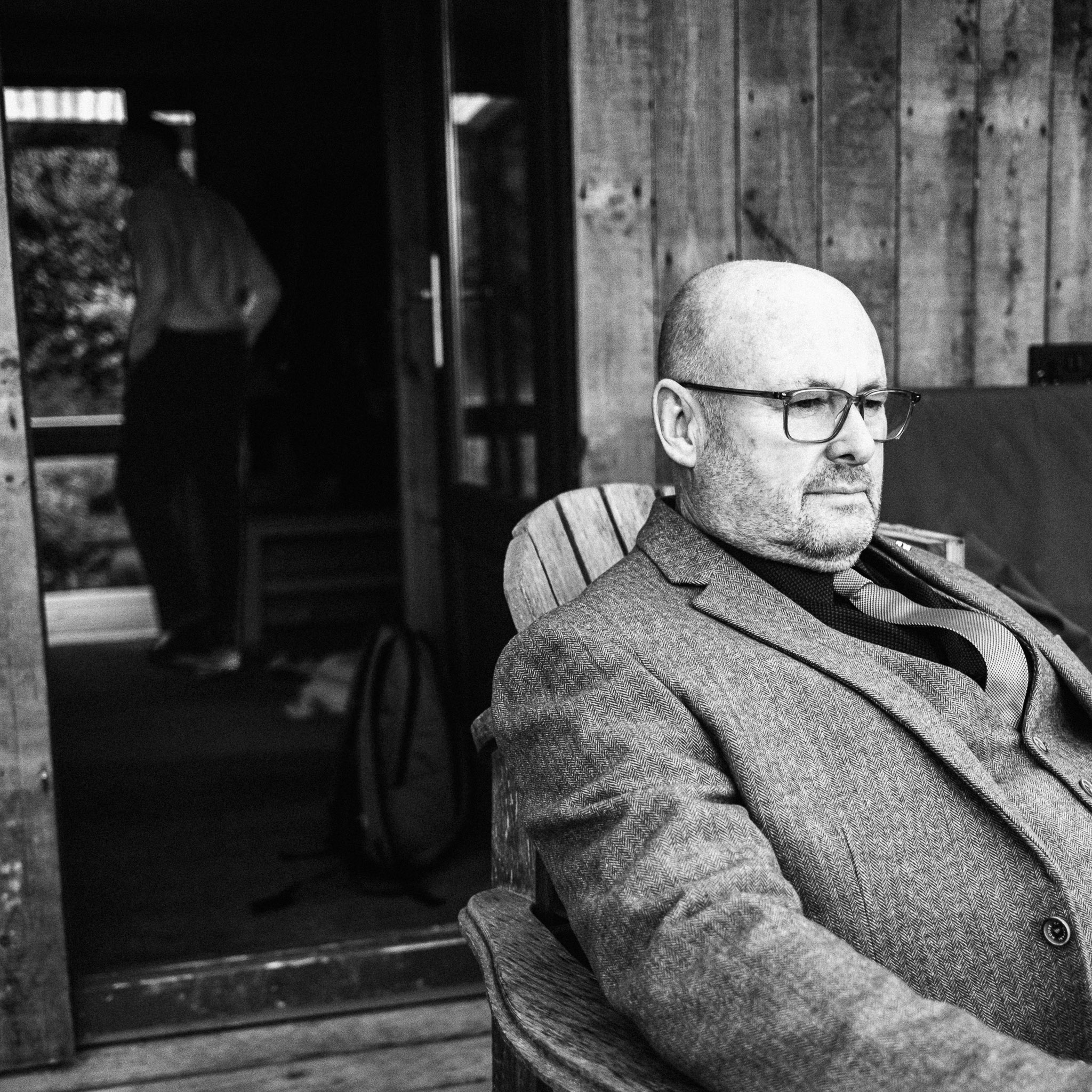 Portrait of an older man seated, formal and reflective.