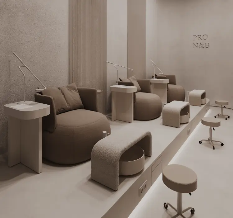 Minimalist nail salon with three brown cushioned chairs, foot baths, and stools on a raised platform.