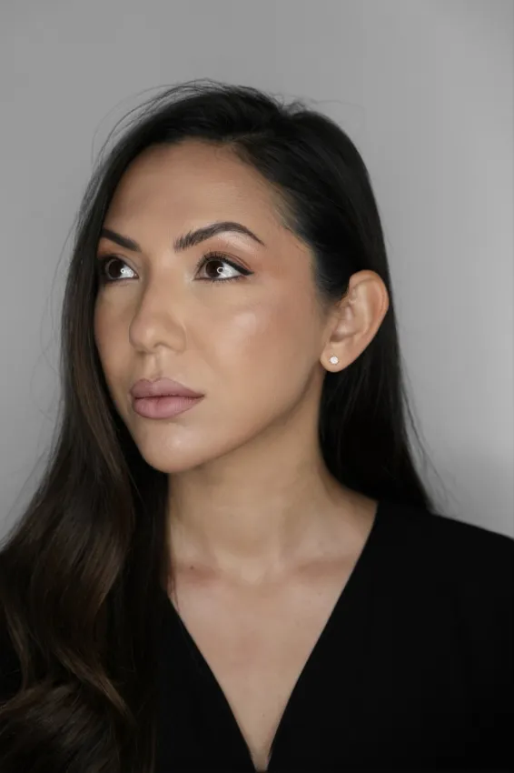 Portrait of a woman with long dark hair looking slightly up and to her left.