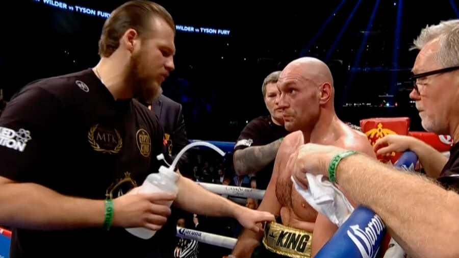 Trainer giving boxer technical instructions