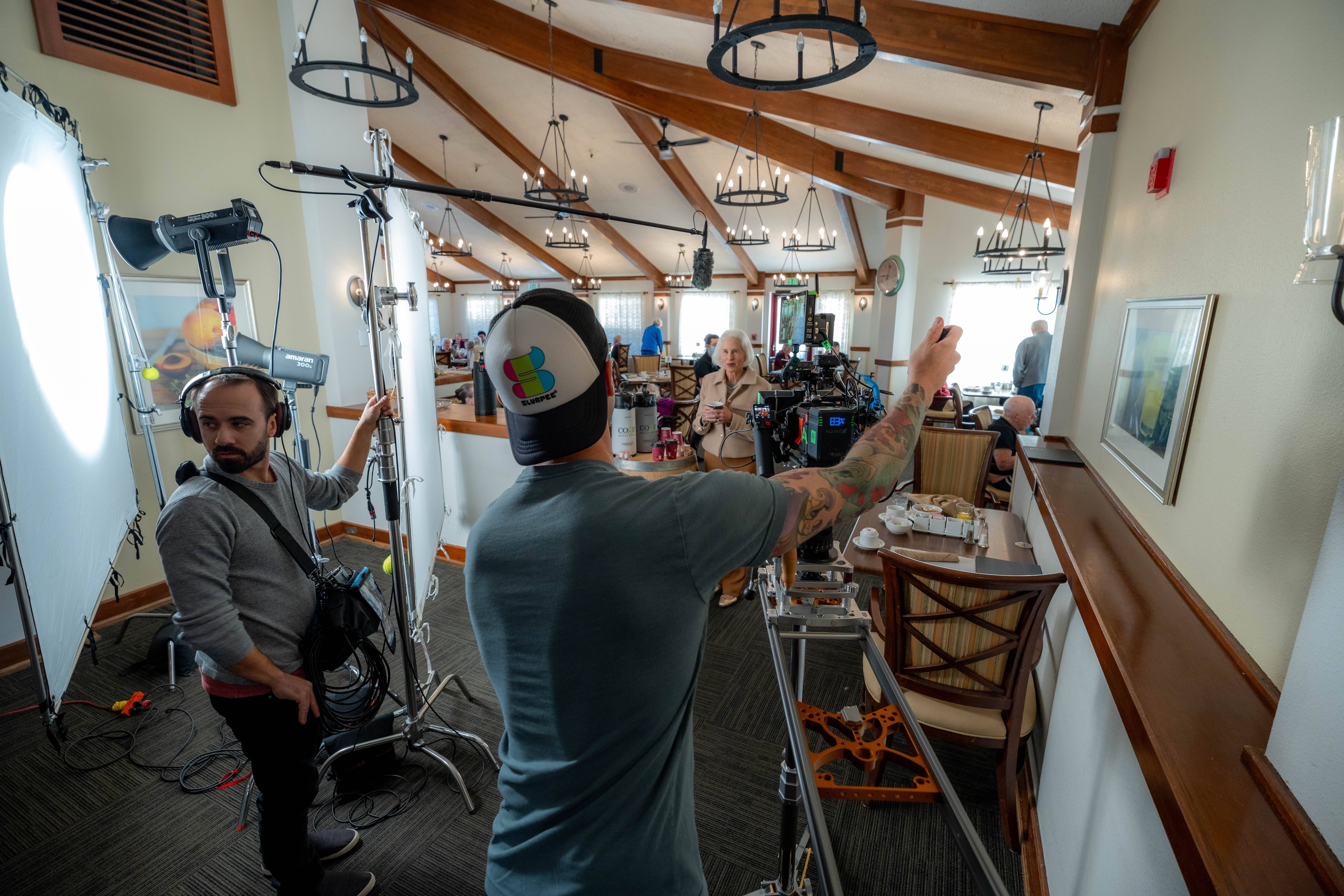 Four people seated in a room with video cameras and one man wearing a Modern Studio Equipment shirt.