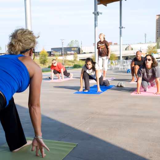 People exercising on yoga mats outside