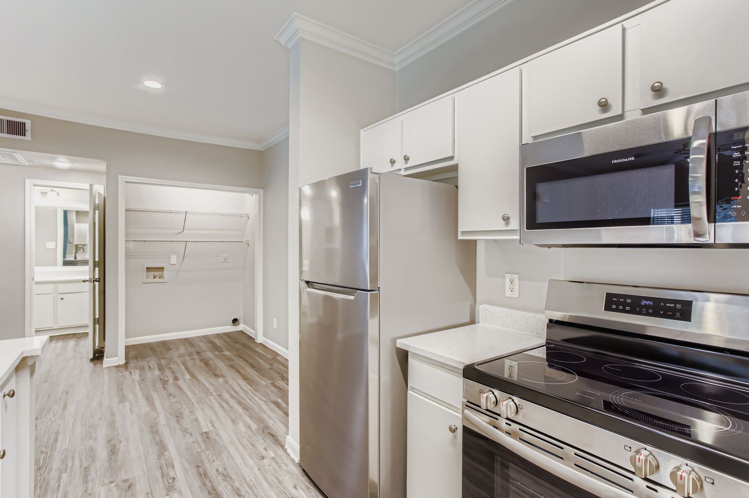 Kitchen with stainless steel stove, microwave, and refrigerator 