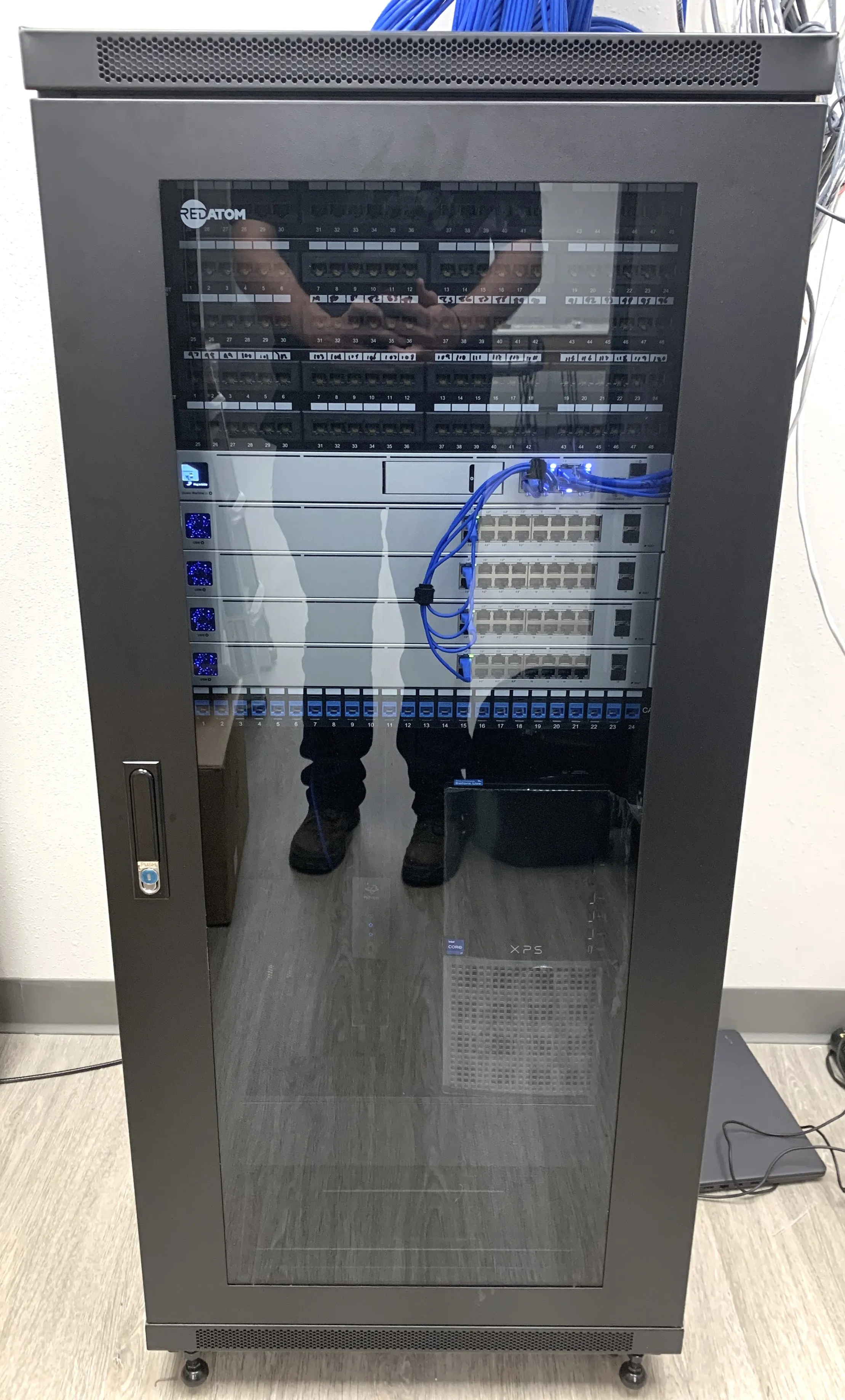 Network cabinet with labeled patch panels, switching, and dressed cable runs