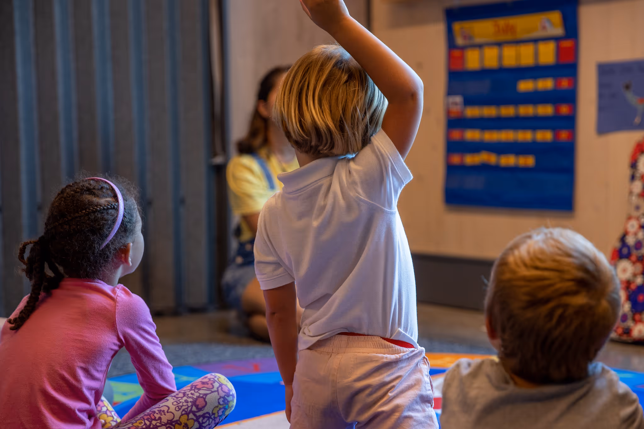 A child Raising their hand.