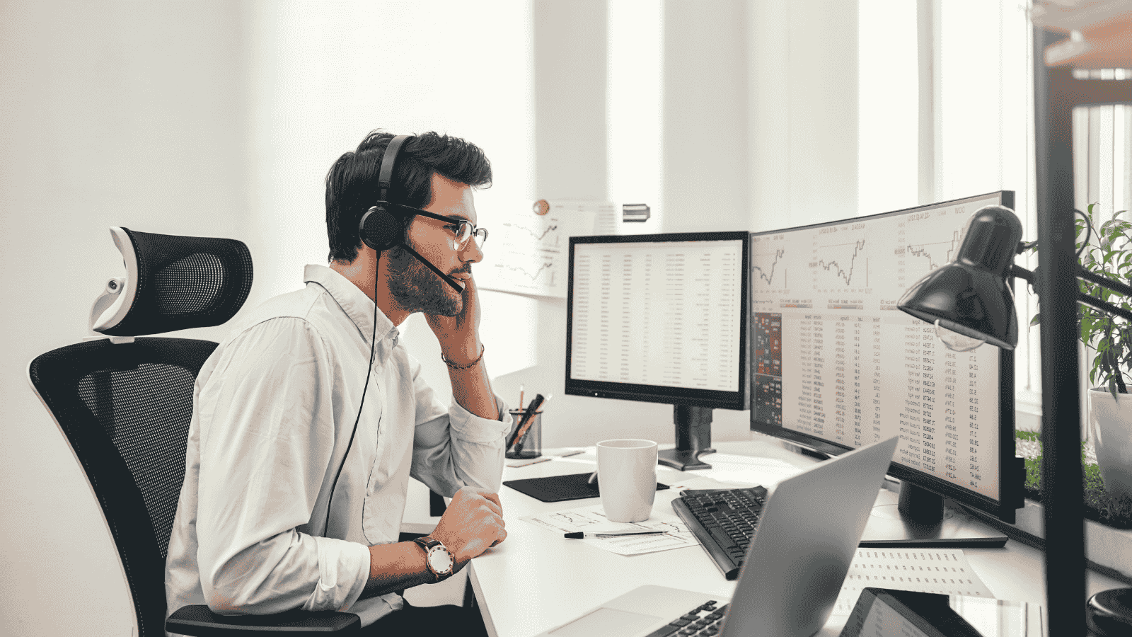 Sales rep using AI tools at desk with data monitors, showing how AI transforms the SDR role through automation and insights.