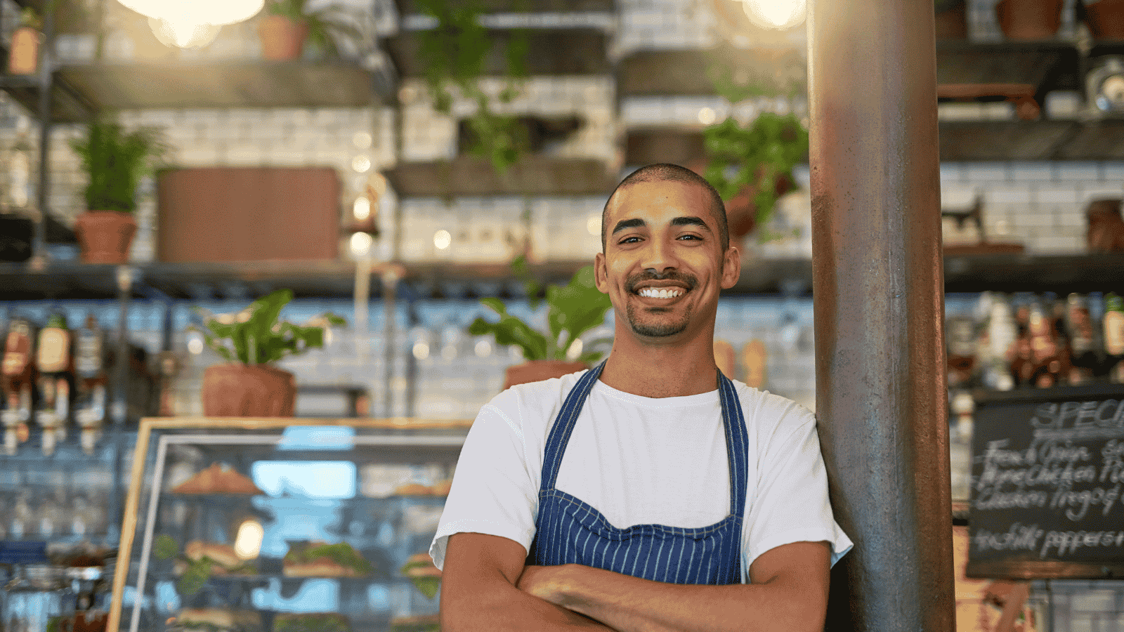 Entrepreneur standing confidently in a small business setting, representing revenue growth through strategy and authentic storytelling.