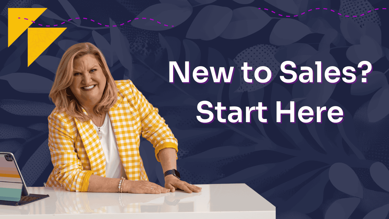 A woman in a yellow suit sitting at a marble desk against a blue background.