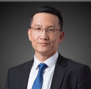 A photograph of Kevin Sun in a dark grey business suite and blue tie.