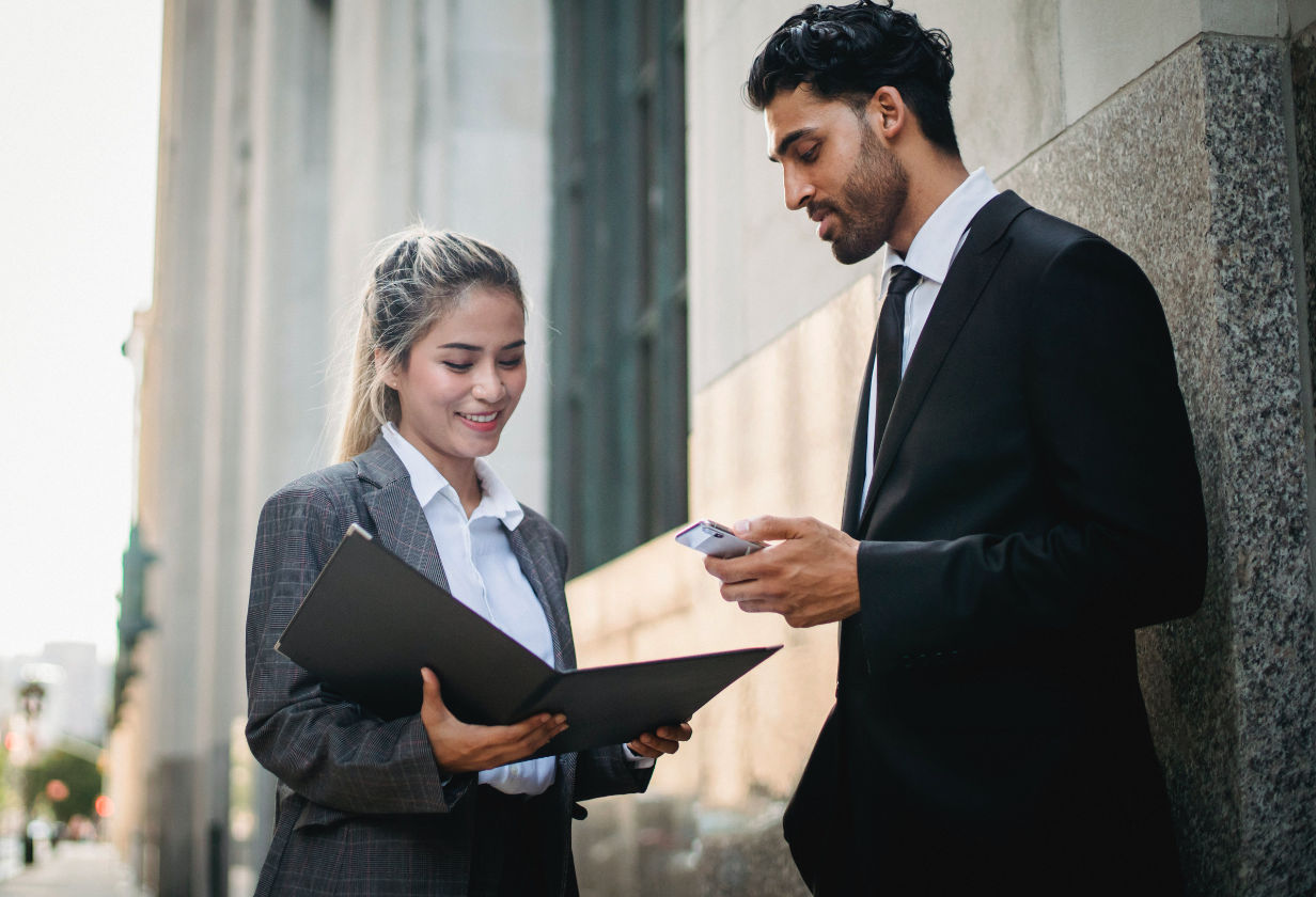Two coworkers discuss a report