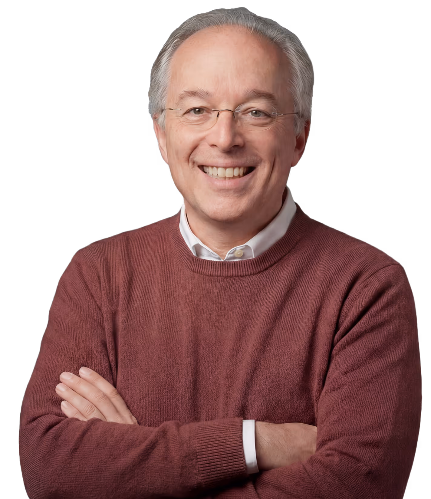 Doktor Gorsler steht in einen dunkelroten Pullover gekleidet, mit verschränktem Armen und einem warmen Lächeln in seiner Praxis für Kinderchirurgie in der Seestraße 98 13353 Berlin.