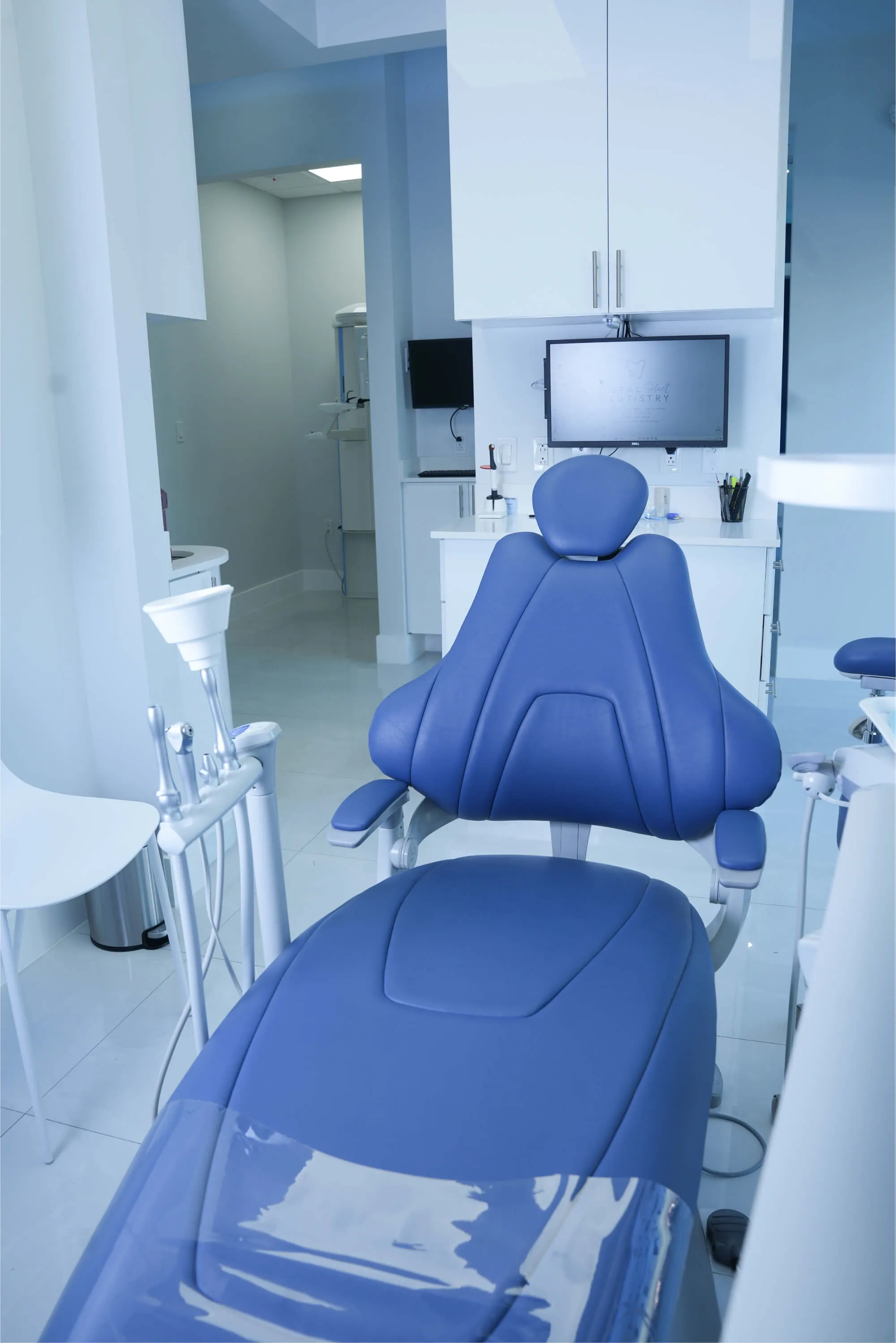 A blue chair in a room with a television.